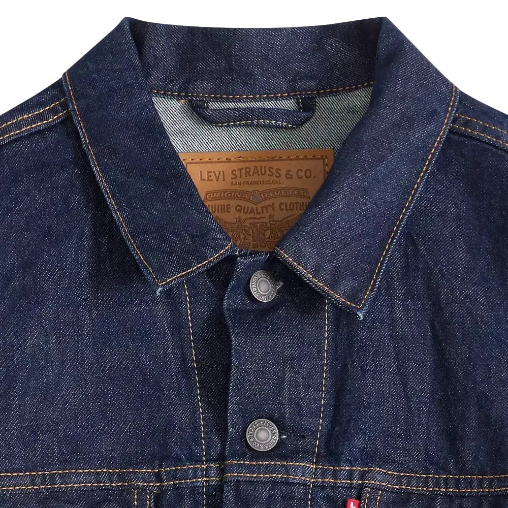 Close-up of a blue denim jacket with Levi's branding on a white background