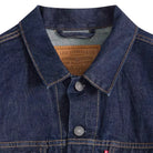 Close-up of a blue denim jacket with Levi's branding on a white background
