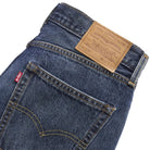 Close-up of blue jeans with Levi's label on a light gray background