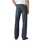 Person wearing blue jeans and a white t-shirt on a plain background