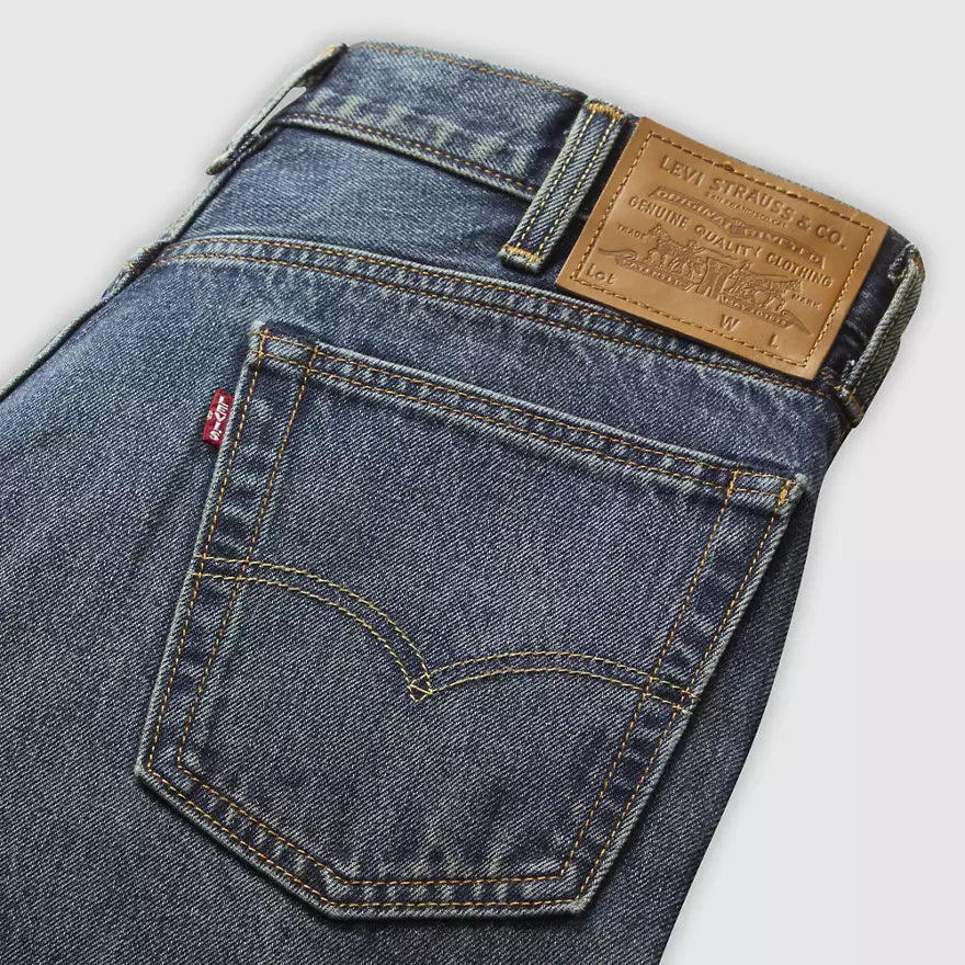 Close-up of Levi's jeans with brand label on a light gray background