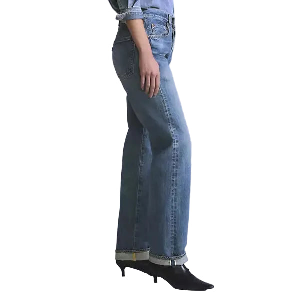 Woman wearing a denim outfit on a white background