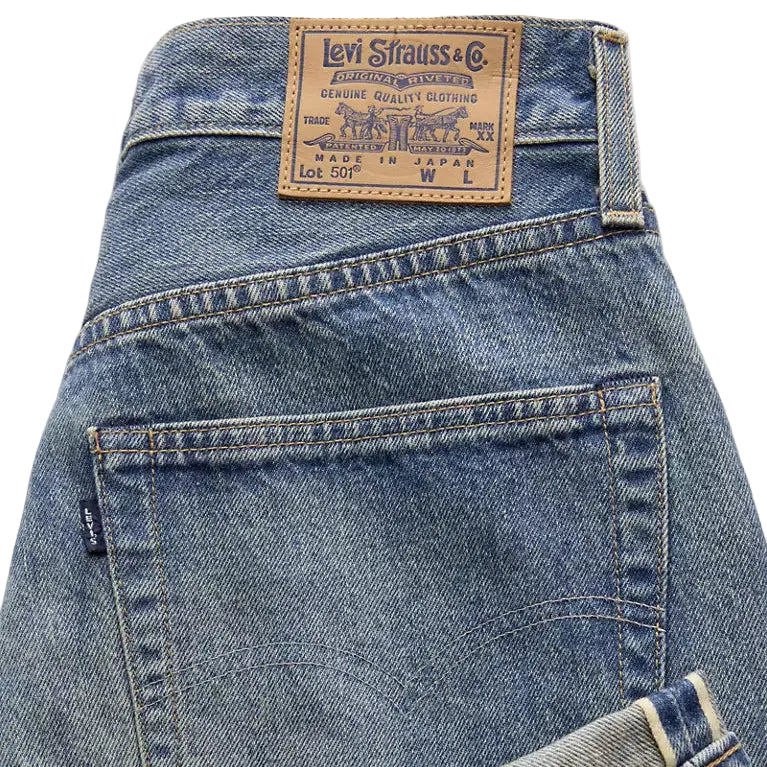 Close-up of a Levi's denim jean with the brand logo on a light gray background
