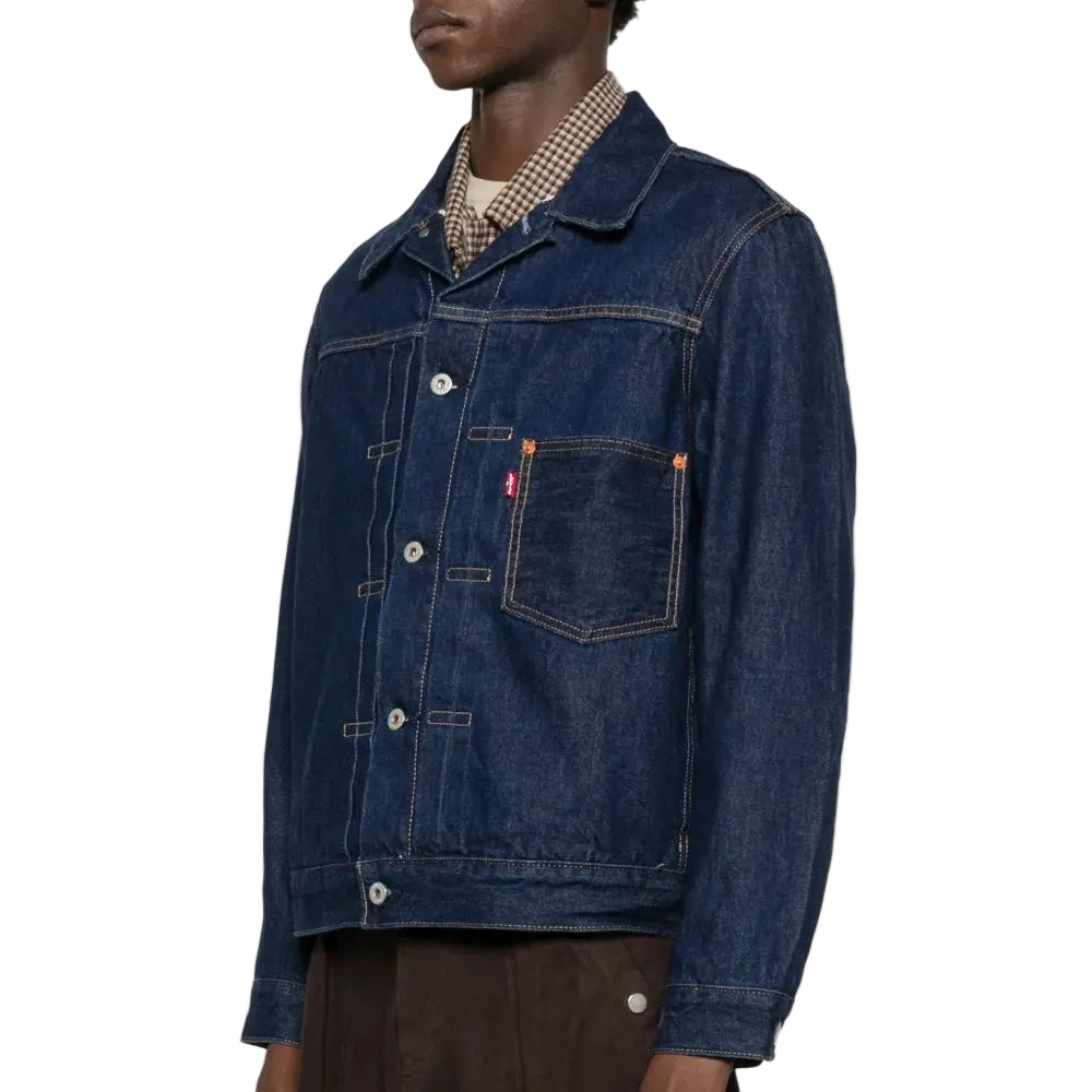 Person wearing a blue denim jacket on a white background