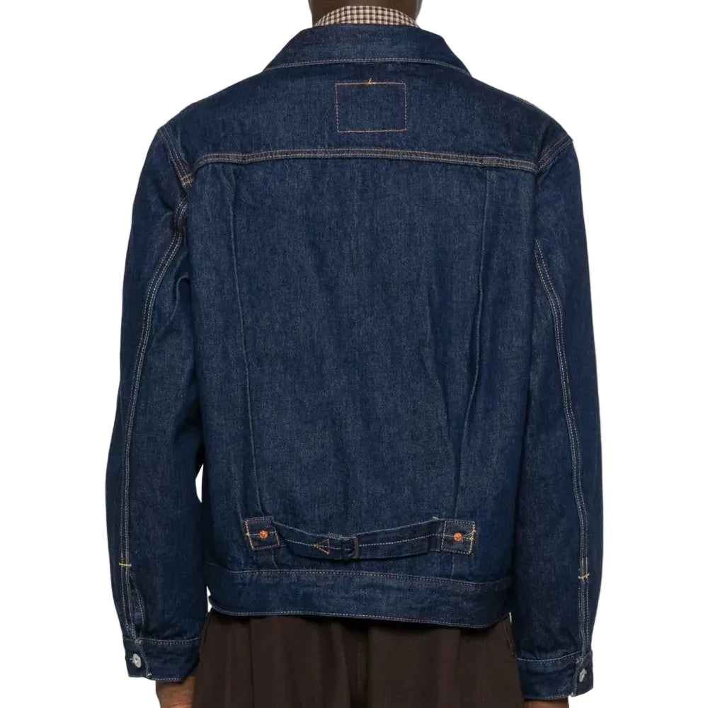 Blue denim jacket worn by a person on a white background