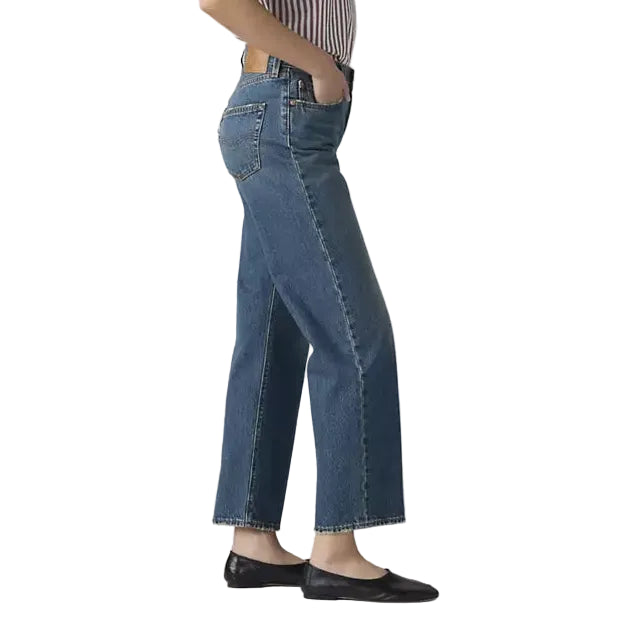 Woman wearing a striped shirt and blue jeans on a white background