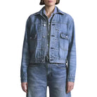 Person wearing a blue denim jacket and jeans on a white background