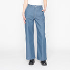 Person wearing blue denim pants on a white background