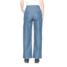 Back view of a person wearing blue denim pants on a white background
