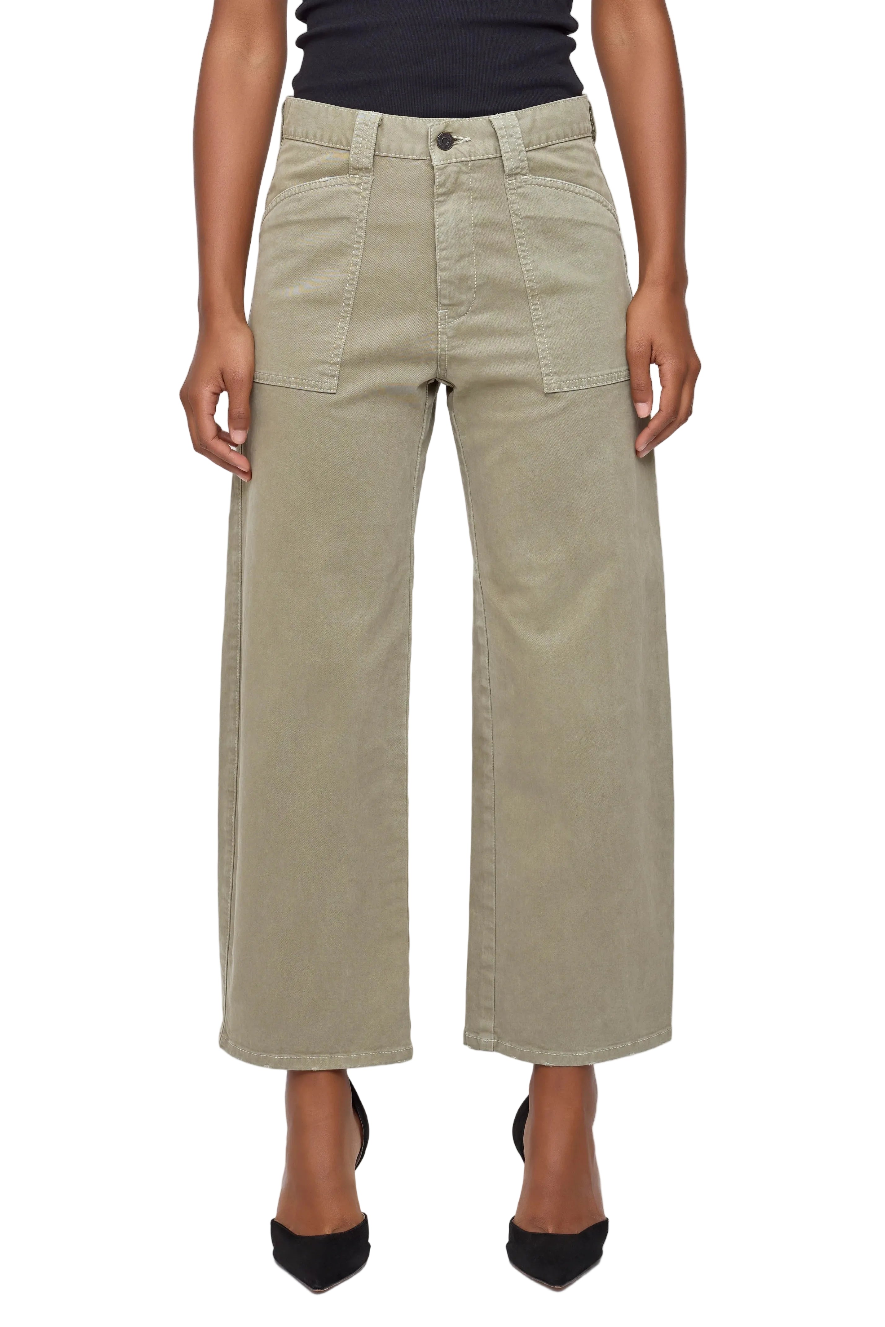 Person wearing beige wide-leg pants on a white background
