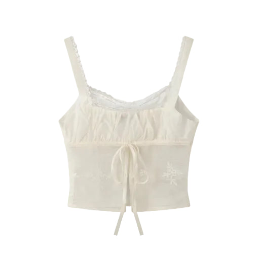 white camisole with delicate floral embroidery on a white background