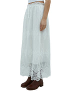 Model in a white lace skirt on a white background