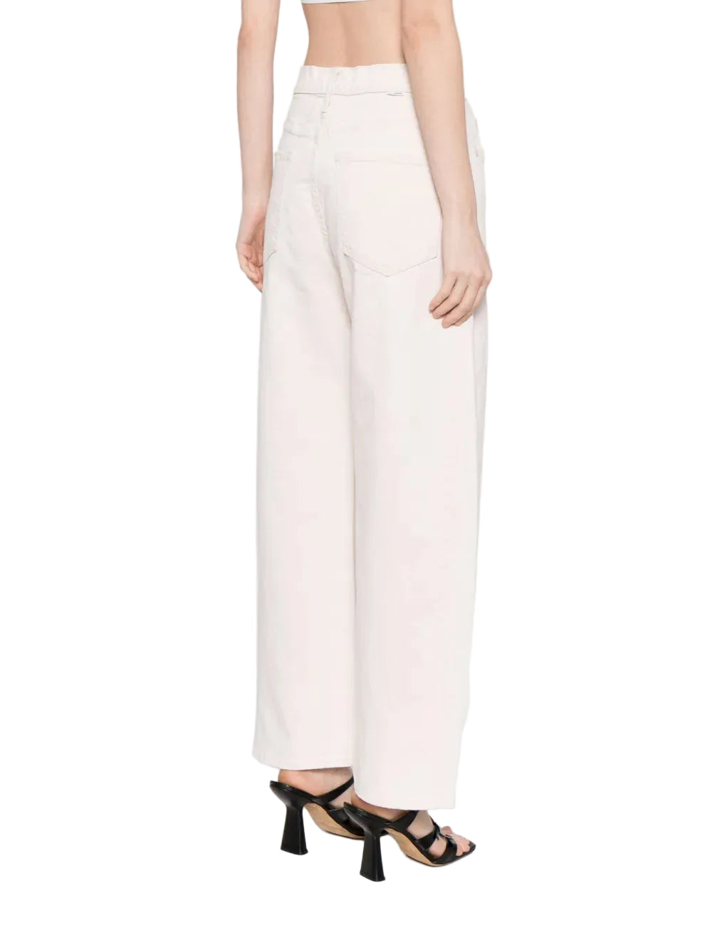 Person wearing white pants on a plain background