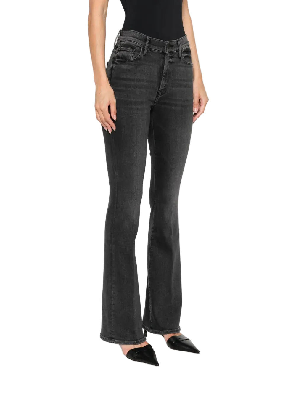 Person wearing black flared jeans on a white background