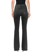 Black flared jeans worn by a person on a white background