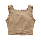 A cropped sleeveless top in a warm taupe-brown linen fabric, featuring ruffled trim along the scoop neckline and armholes, laid flat against a white background.
