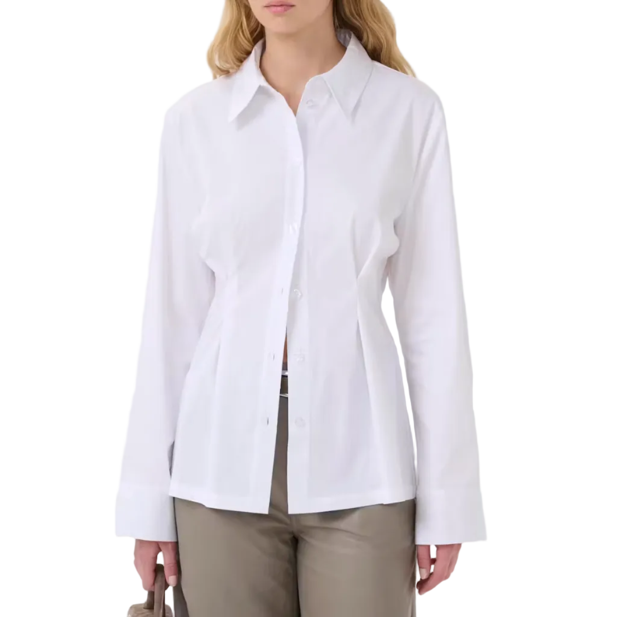 A woman modeling a white long-sleeve button-up shirt with a pointed collar and front pleats, paired with taupe trousers, against a plain white background.