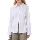 A woman modeling a white long-sleeve button-up shirt with a pointed collar and front pleats, paired with taupe trousers, against a plain white background.