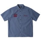 Blue workshirt with embroidered logos on a white background