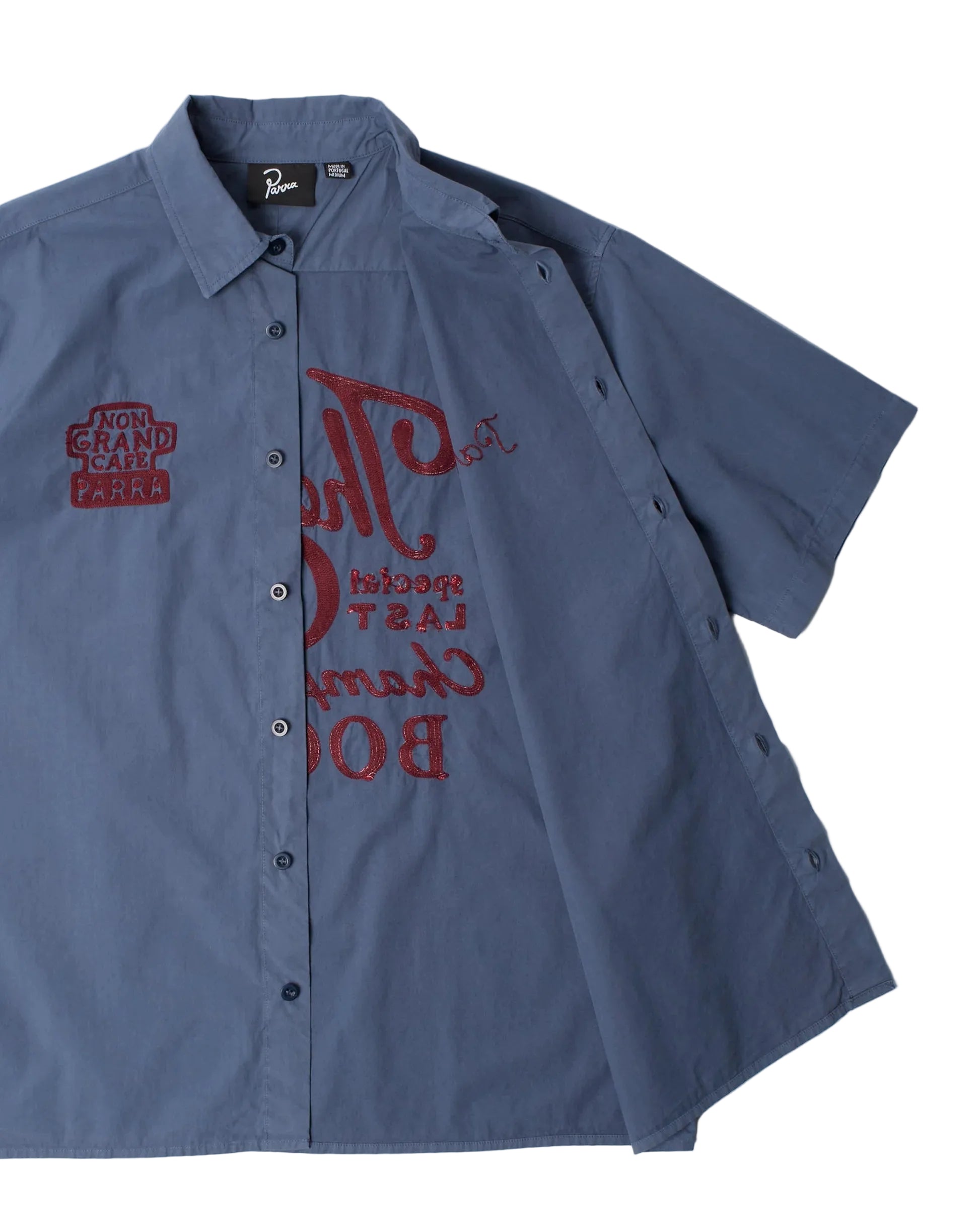 Blue workshirt with embroidered logos on a white background