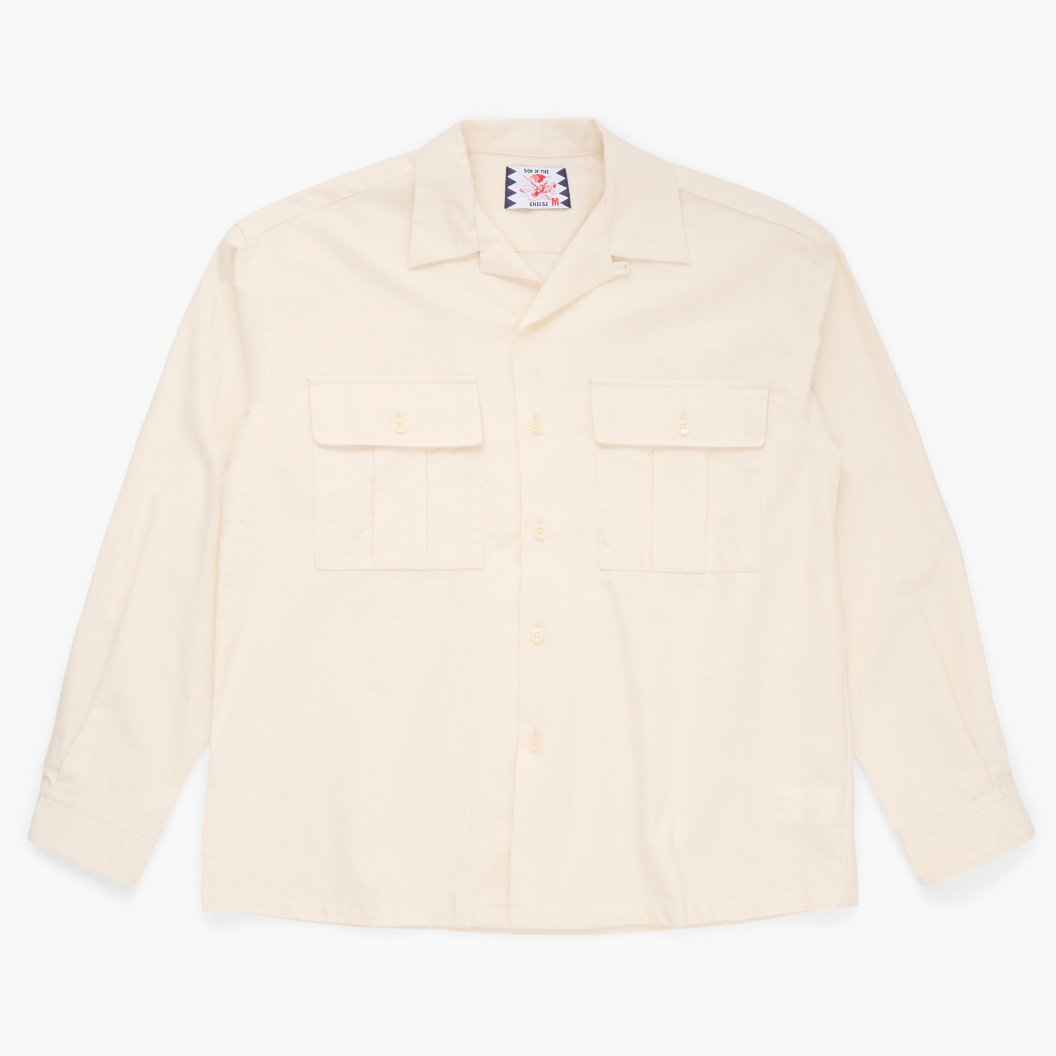 Cream button down shirt on a white background