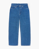 Wide leg blue jeans on a white background