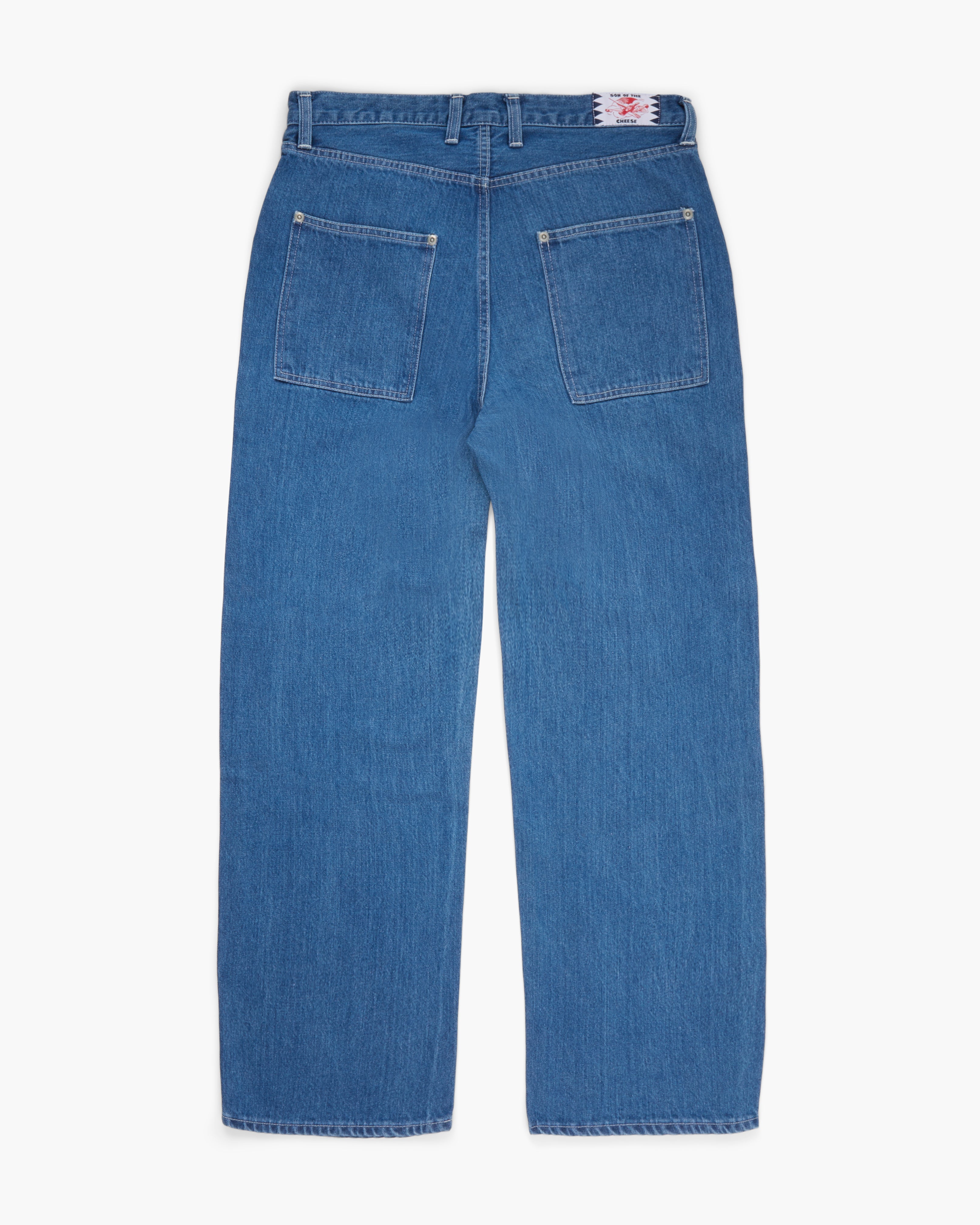 Wide leg blue jeans on a white background