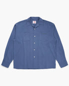 Blue button down shirt on a white background
