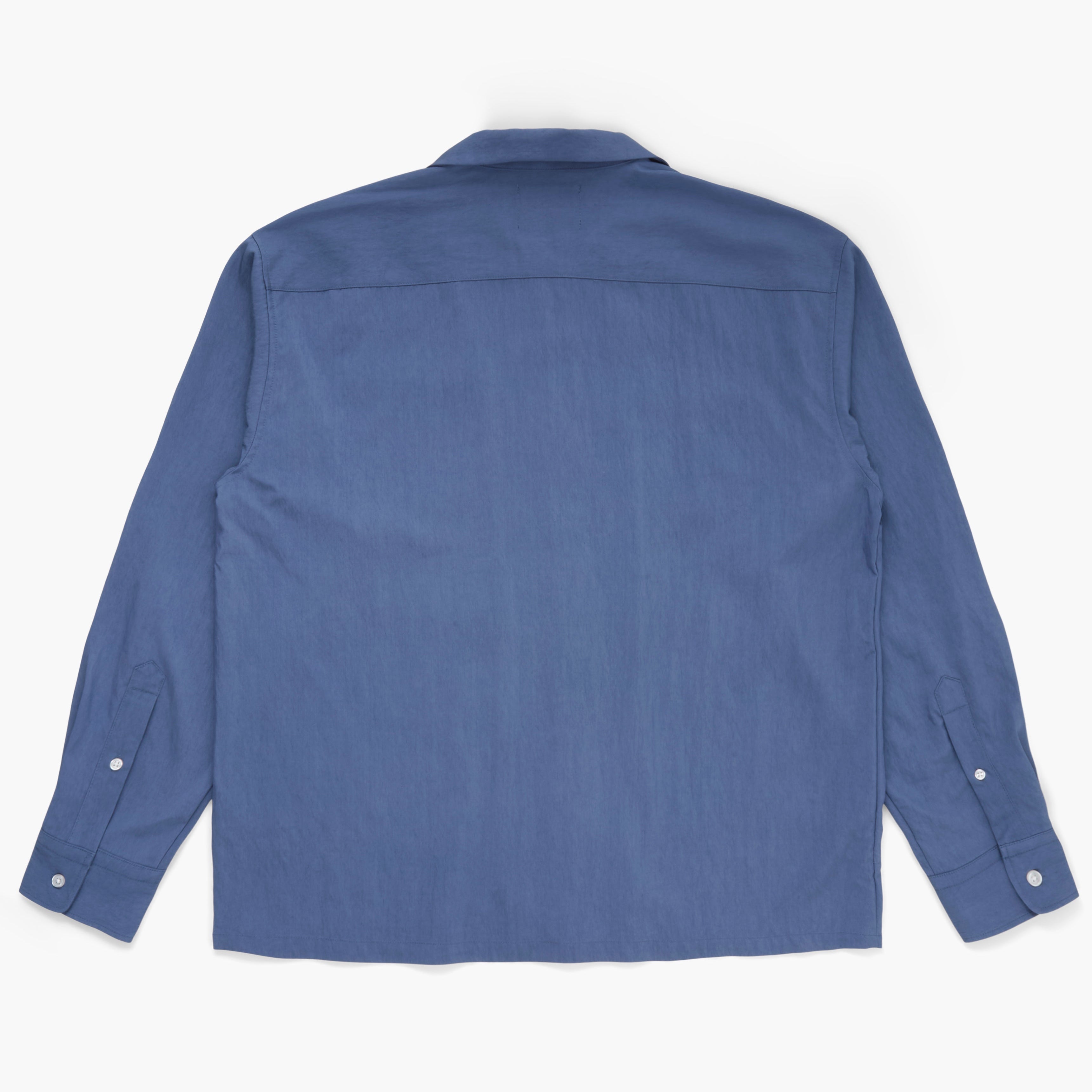 Back view of a blue button down shirt on a white background