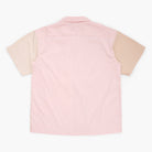 Beige, tan, and pink button down shirt on a white background 
