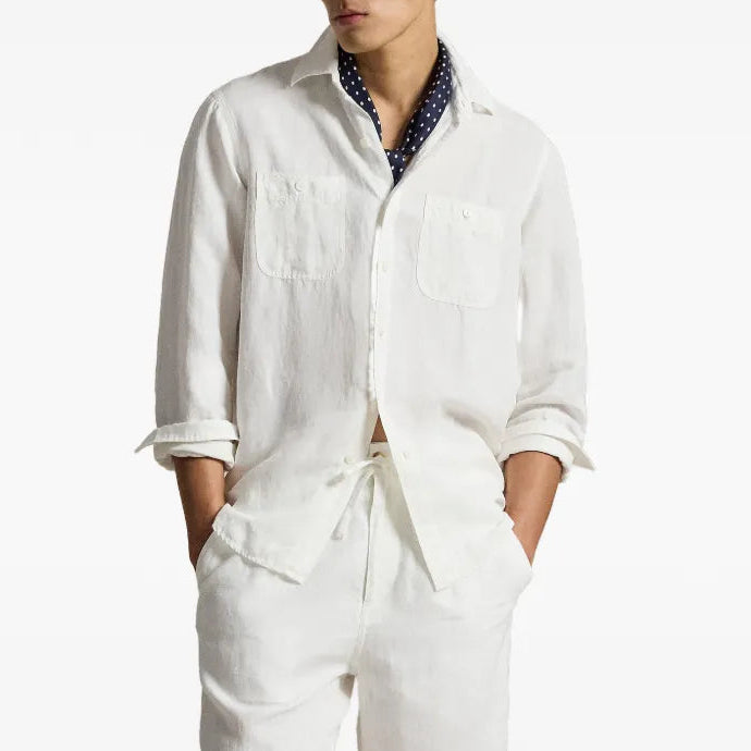 Person in a white workshirt with a blue scarf on a white background