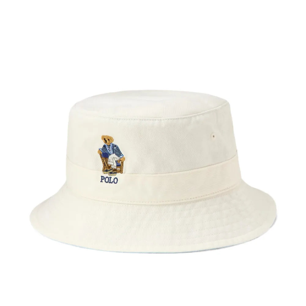 White bucket hat with an embroidered bear logo on a white background