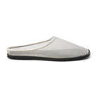 White mesh mule with a flat black sole on a white background 