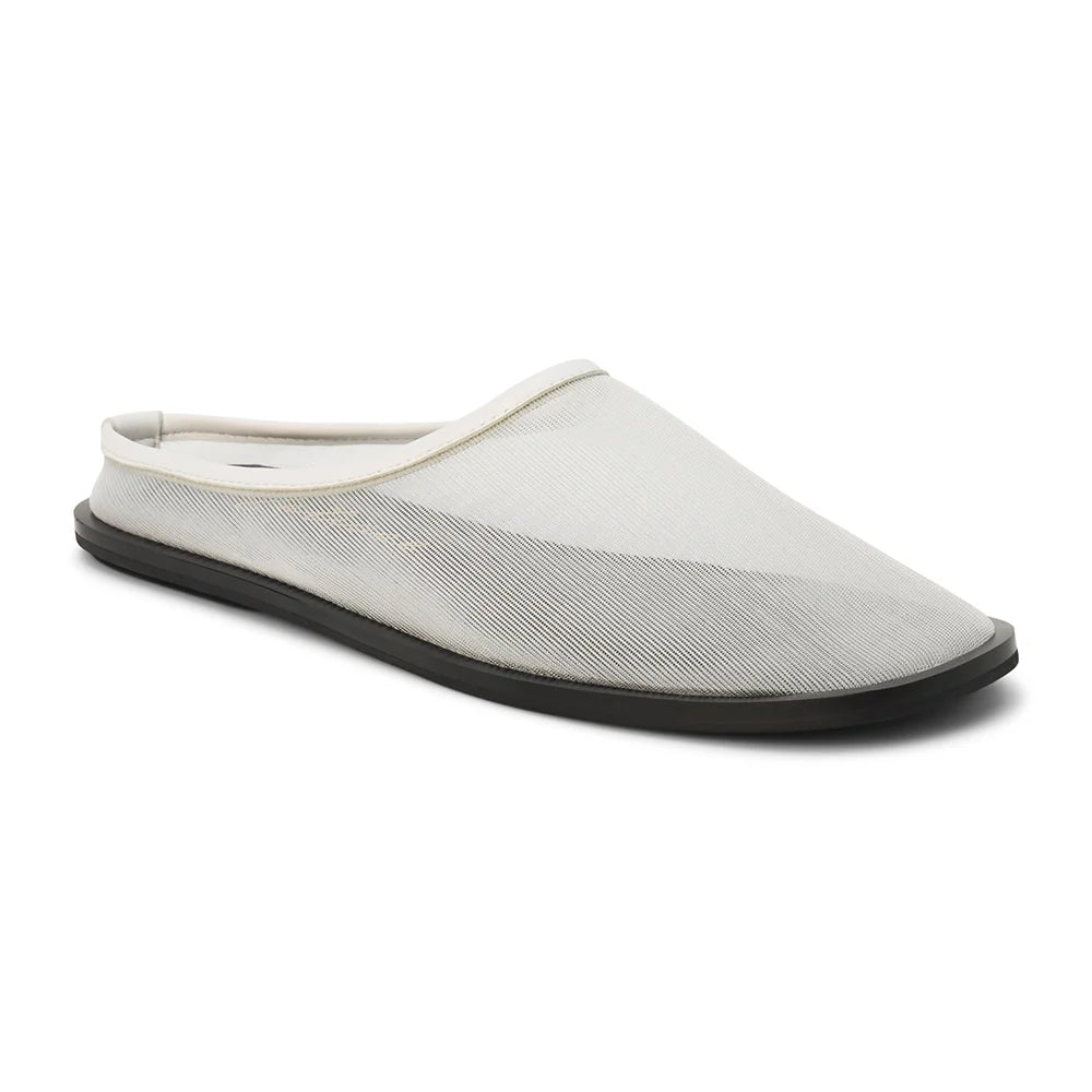 3/4 view of a white mesh mule with a flat black sole on a white background 