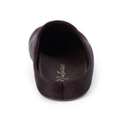 A single dark plum-colored slip-on shoe shown from a top-down view on a white background, featuring a textured finish and the brand name 'Matisse' printed in gold on the insole.