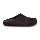 Pair of dark purple cow hair clog shoes on a white background