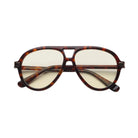 Tortoise framed sunglasses with yellow lenses and gold accents on a white background