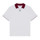 White polo with a maroon collar and logo at the chest on a white background