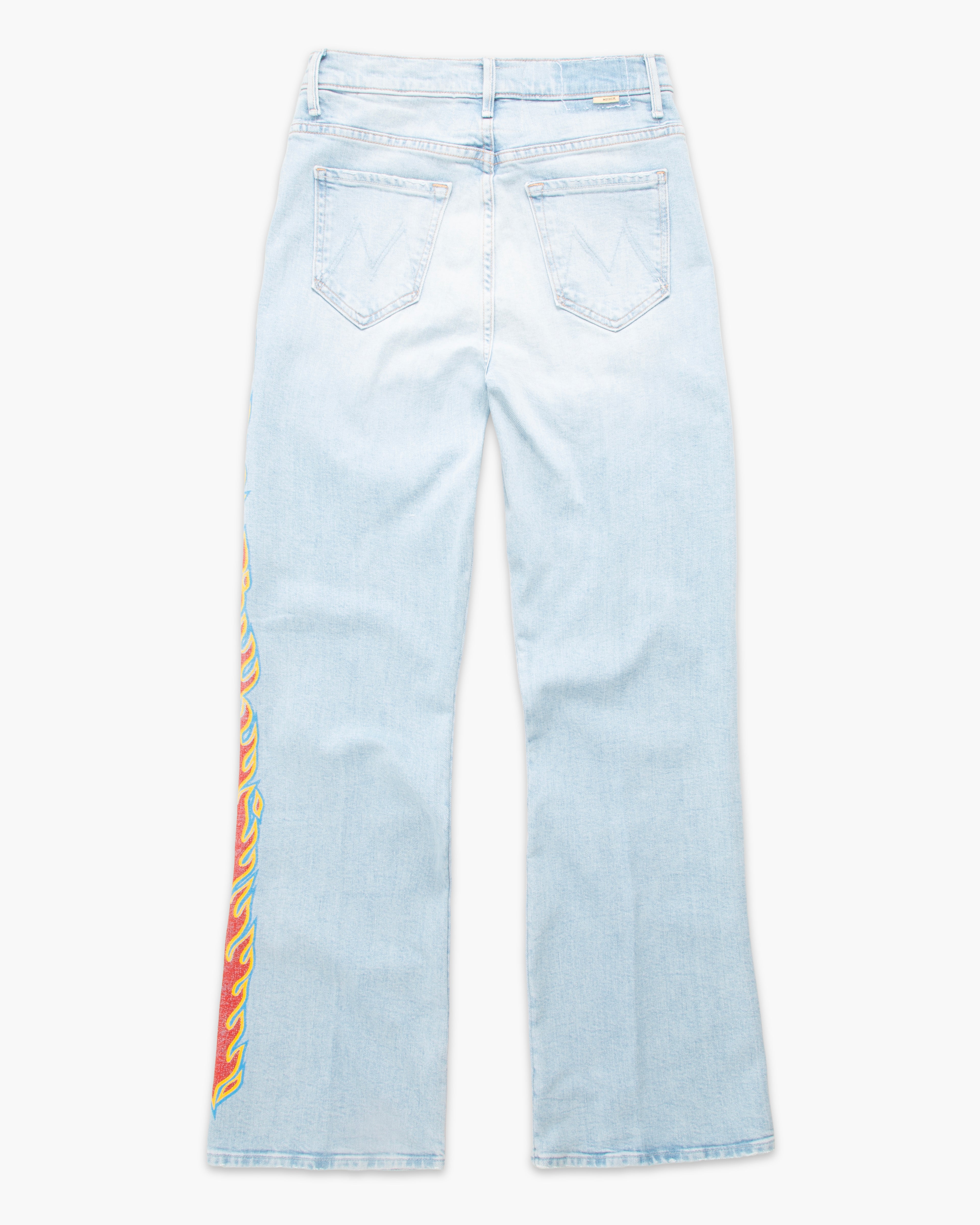 Light wash blue denim jeans shown from the back, featuring a colorful vertical flame graphic print in red, yellow, and green on the left leg.