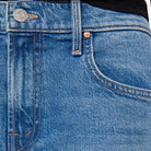 Close-up of blue jeans with a brand logo on the button area.