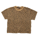 A short-sleeve crewneck t-shirt with an all-over leopard print pattern in brown and tan, laid flat against a white background.