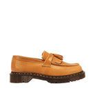 A tan leather tassel loafer shoe with a dark brown sole, shown in profile against a white background.
