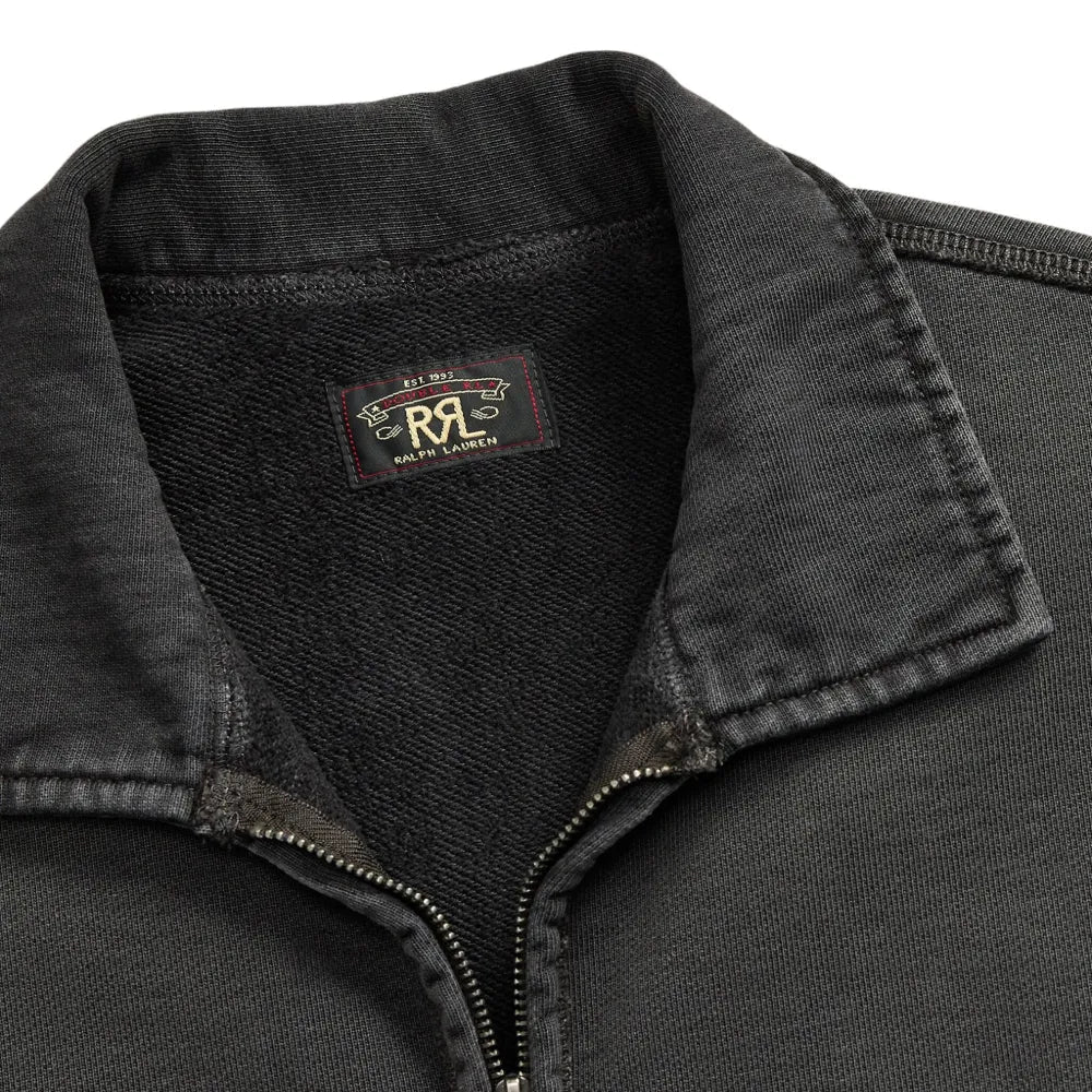 Close-up of a dark charcoal gray quarter-zip pullover sweater with a ribbed collar and a visible RRL brand label inside the neck.