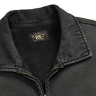 Close-up of a dark charcoal gray quarter-zip pullover sweater with a ribbed collar and a visible RRL brand label inside the neck.