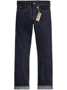Dark blue jeans with a tag on a white background