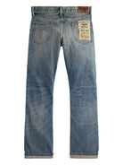 Blue jeans with a brand label on a white background