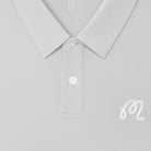 Close-up of a light gray polo shirt showing the collar, button placket, and a small white embroidered script logo on the chest.