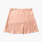 A peach-colored silk A-line mini skirt with a subtle sheen, laid flat against a clean white background.