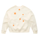 Back view of an off-white crewneck sweatshirt with five orange embroidered stars scattered across the front, displayed flat against a clean white background.