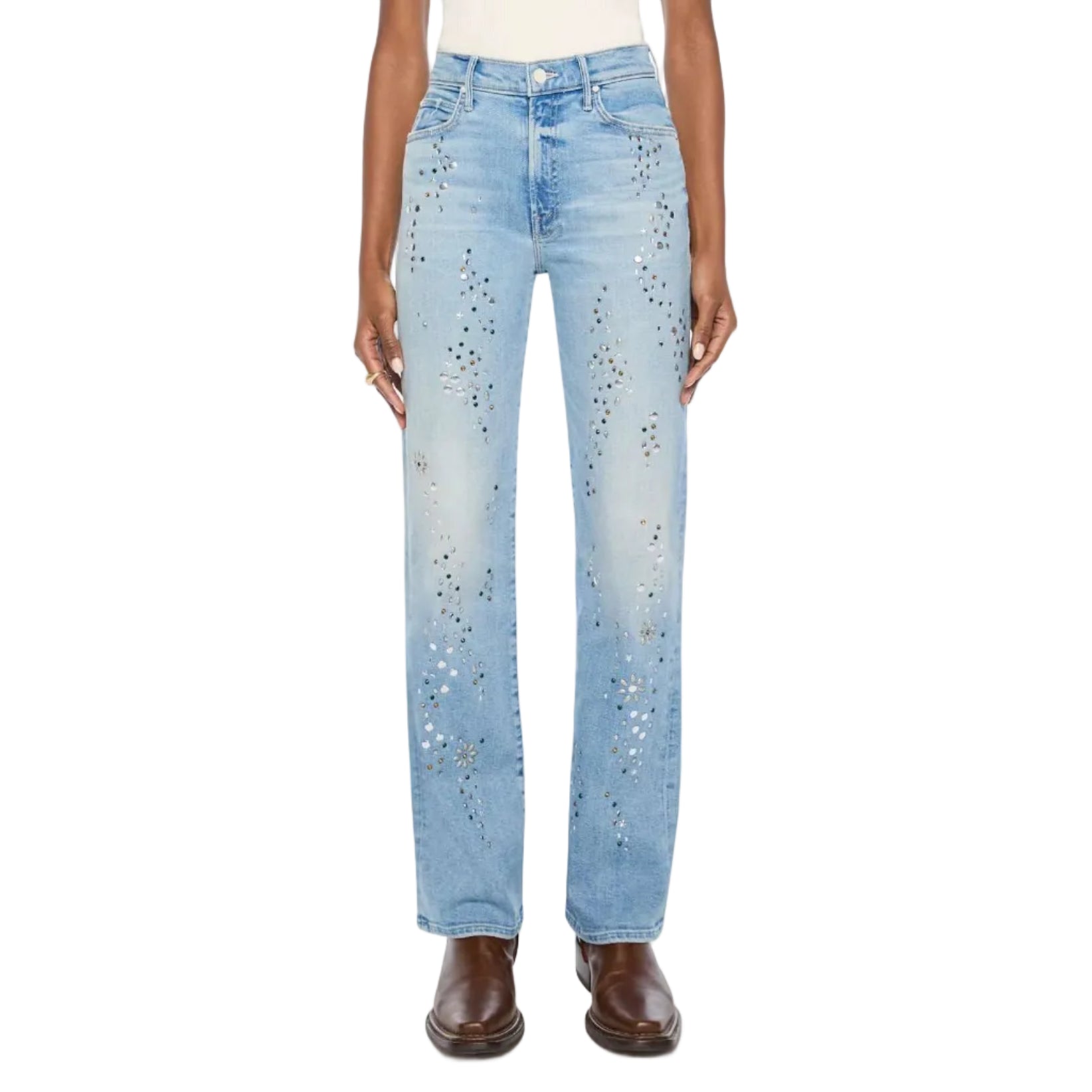 A model stands against a light gray studio background wearing light-wash blue jeans with small scattered rhinestone embellishments, a white top, and brown shoes.